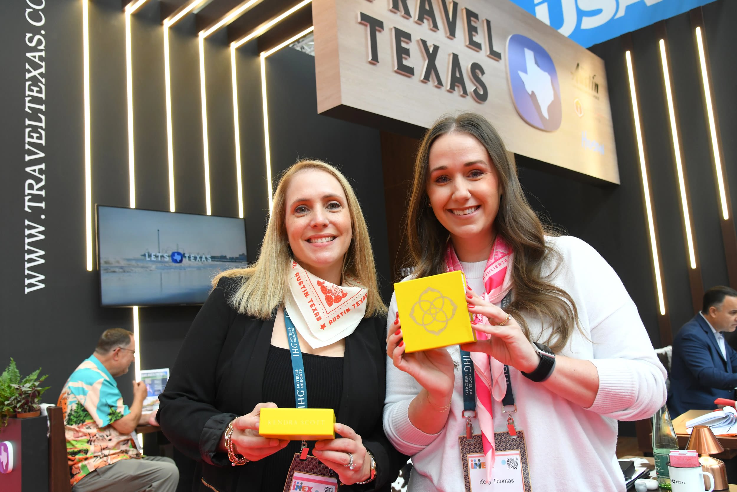 Two people holding giveaway boxes