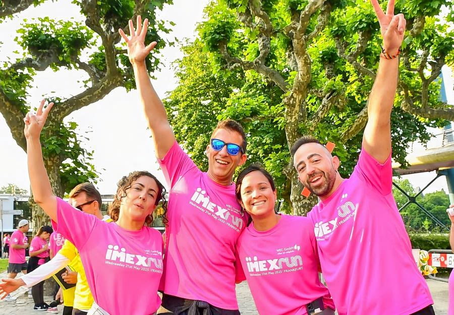 Four people wearing pink t-shirts