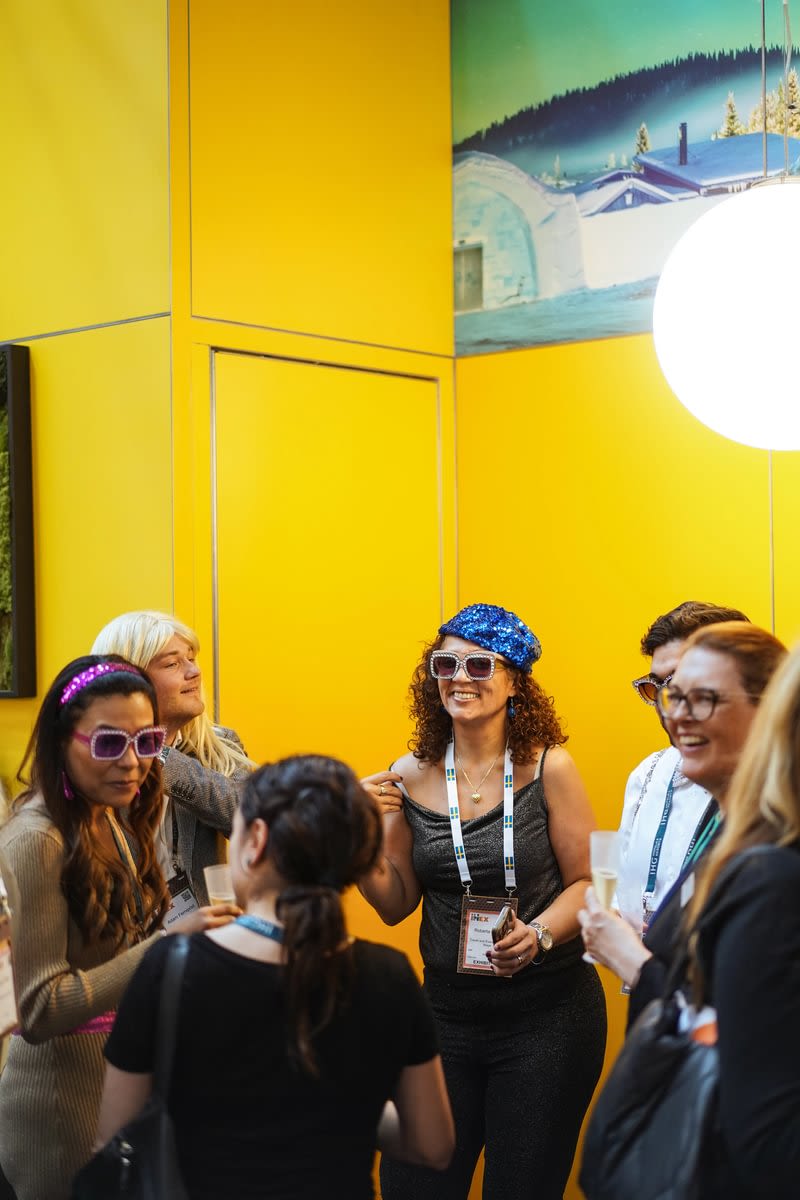 People smiling with colourful accessories 