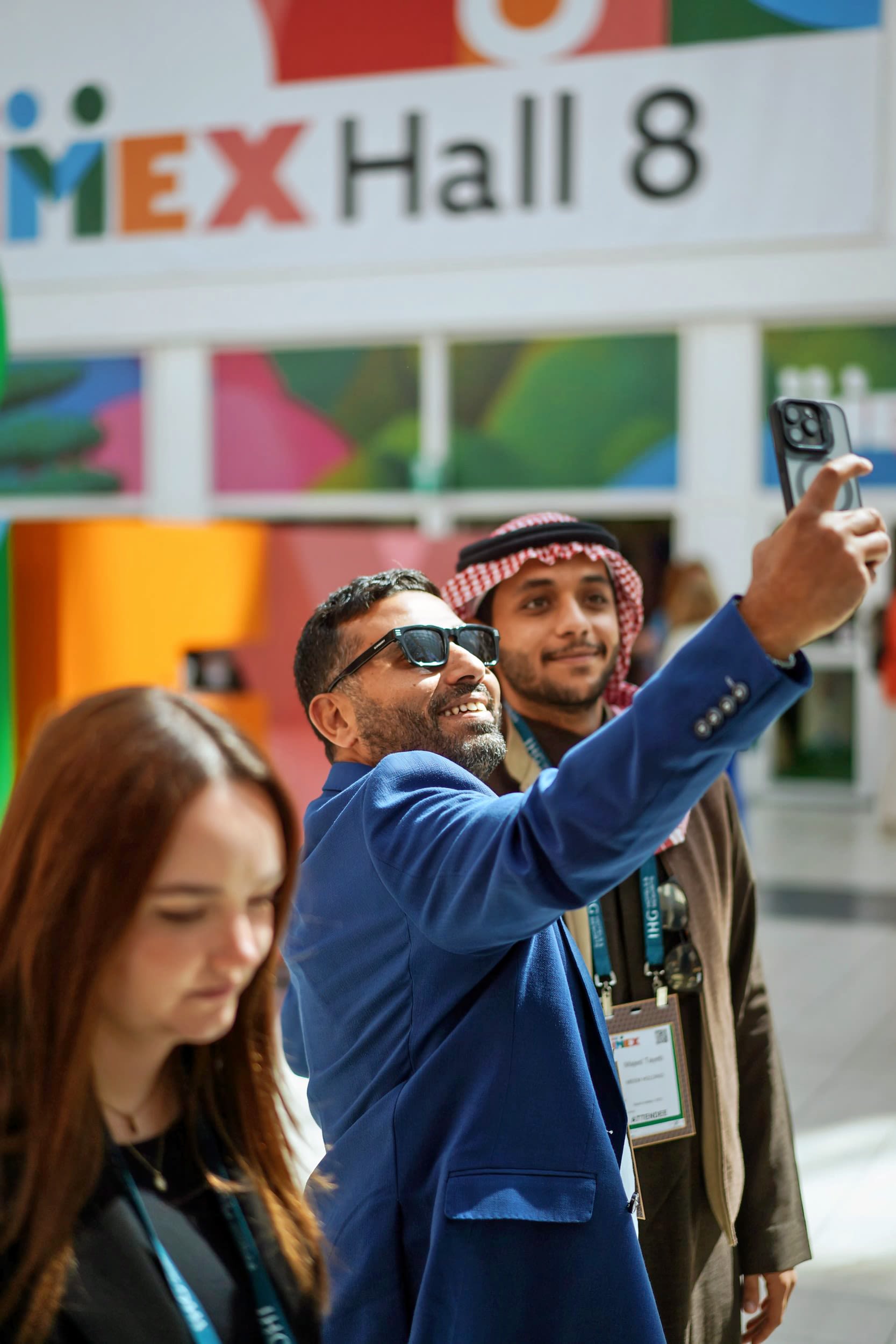 People taking selfie with IMEX sign