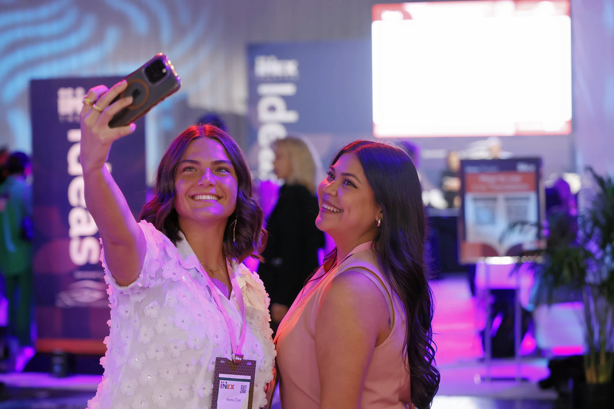 Two females smiling and enjoying a selfie on the inspiration hub floor.