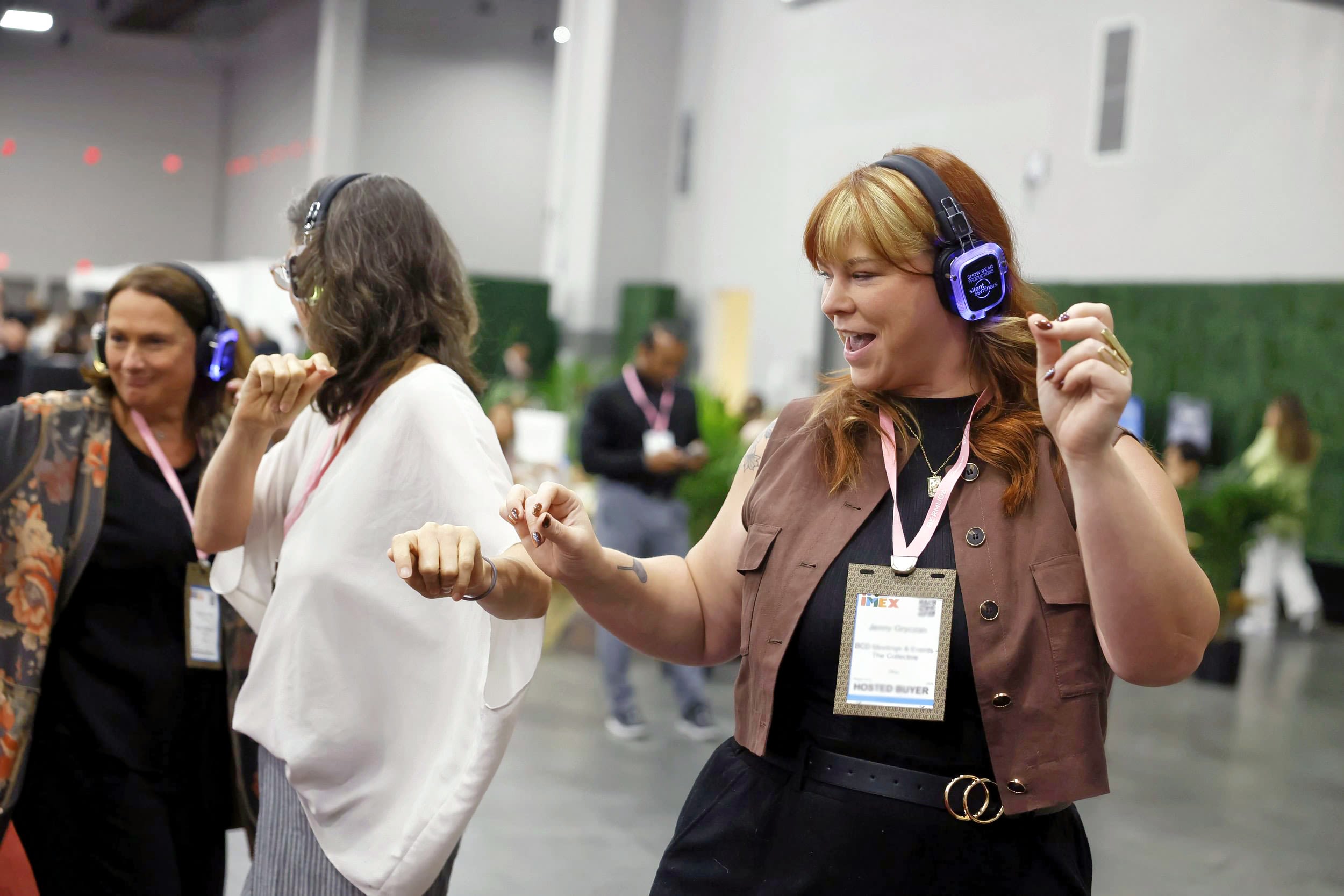 Female dancing with glowing headphones at the tech hub