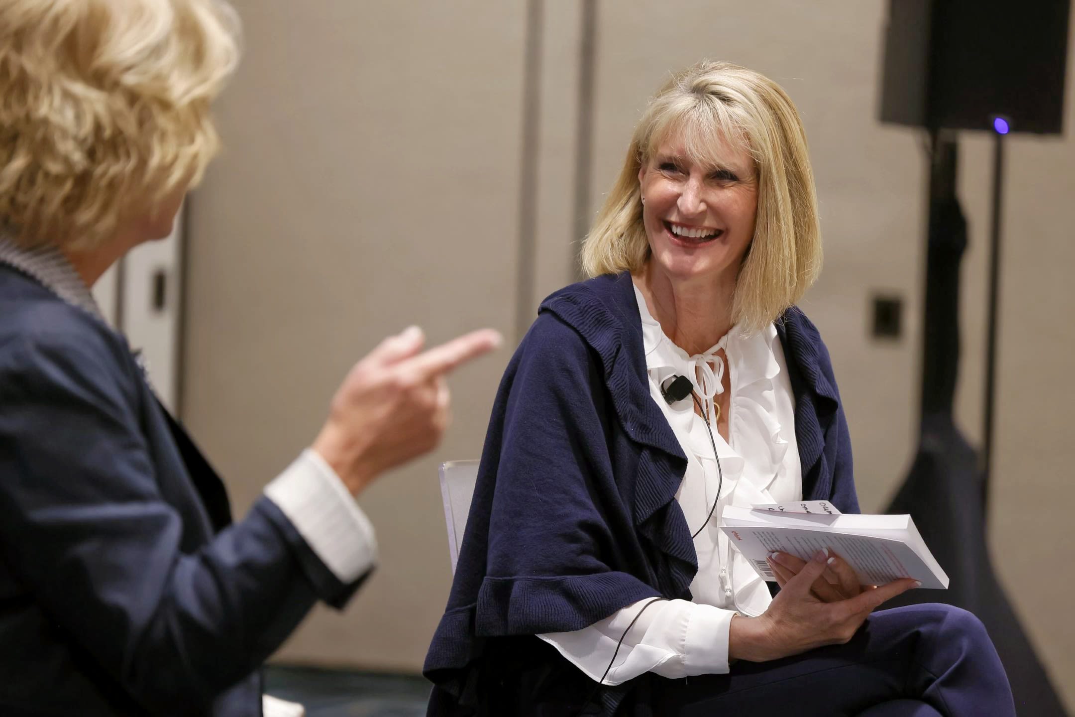 Woman smiling at another person