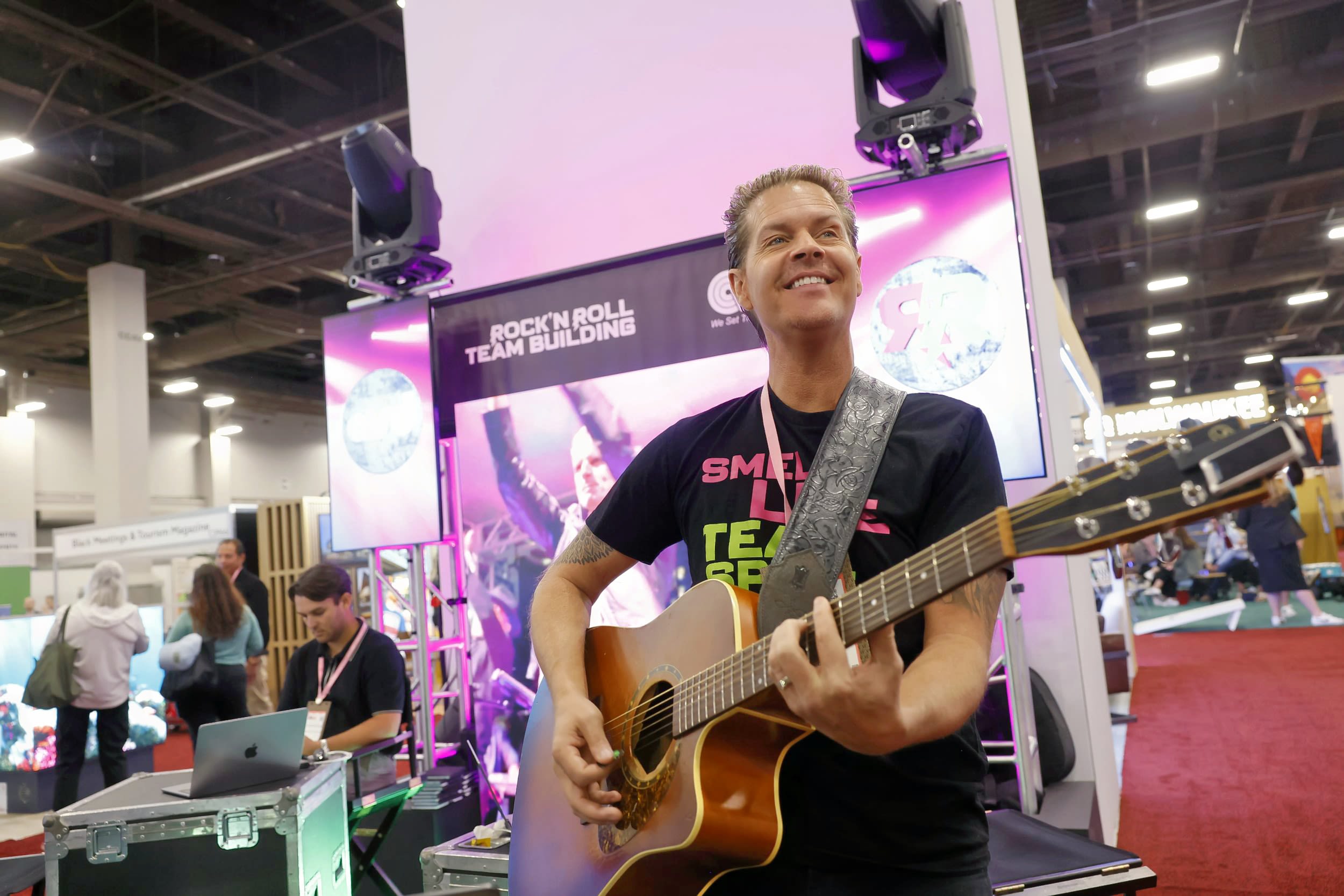 Man playing guitar on show floor