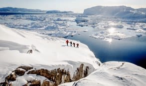 People hiking across a glacier